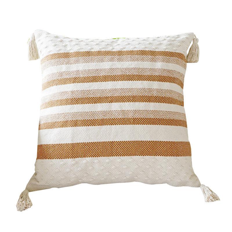 Two shades of brown striped cushion with a white background, tassels on each corner and a textured feel on the bottom and top