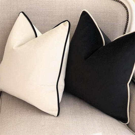 Black and white velvet cushions with piped edges showing a soft luxury inner  and an outer modern approach to luxury